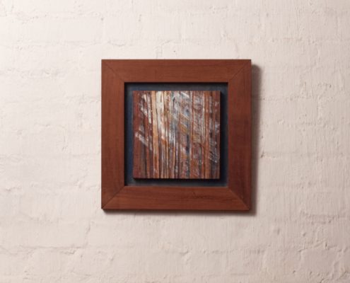 Semi abstract artwork of light through trees out of veneer and acrylic in wooden frame