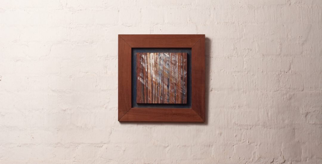 Semi abstract artwork of light through trees out of veneer and acrylic in wooden frame